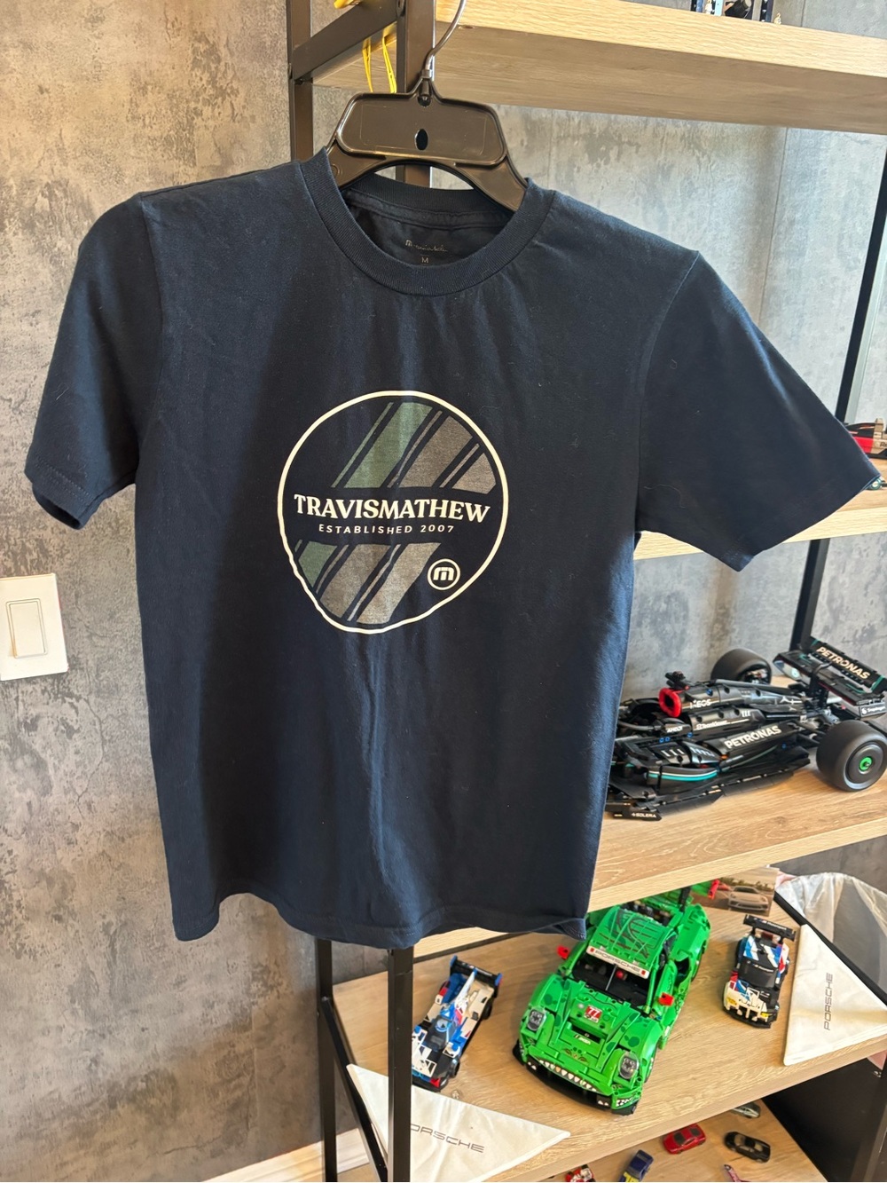 Travis Mathew Navy Blue Boys Graphic Tee with White & Green Logo